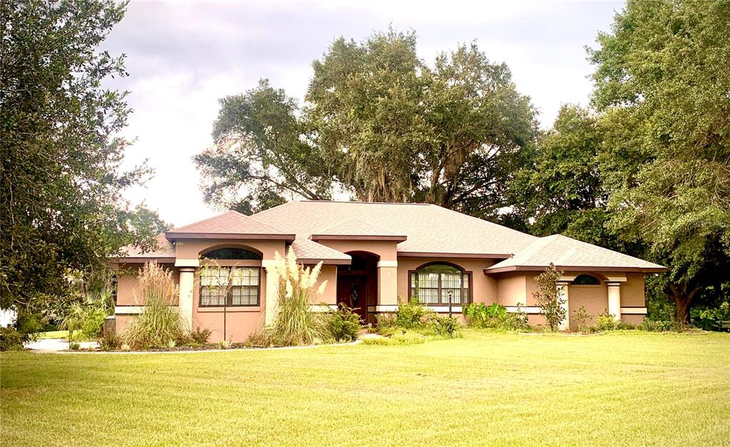 a front view of a house with swimming pool having outdoor seating