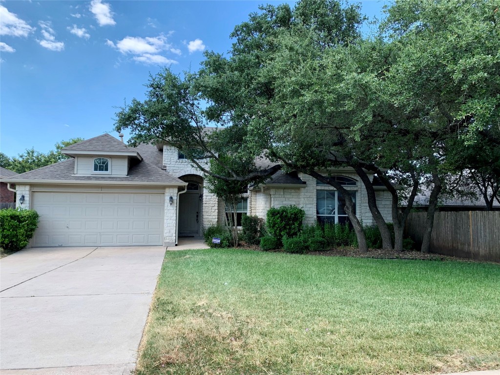 a front view of house with yard and green space