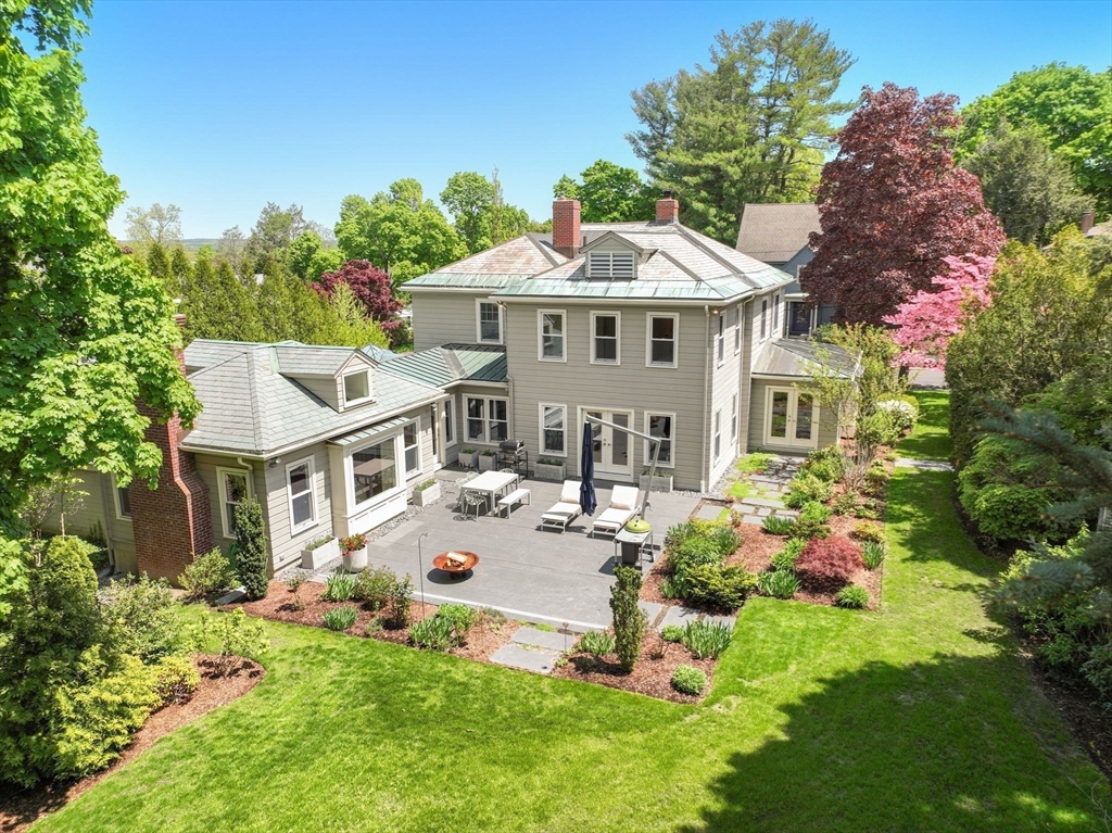 a aerial view of a house with yard and green space