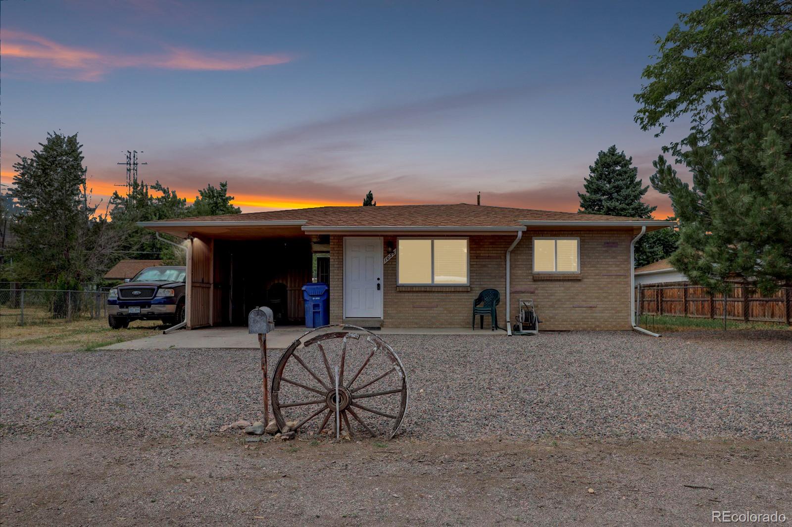 a view of a house with a patio and a yard