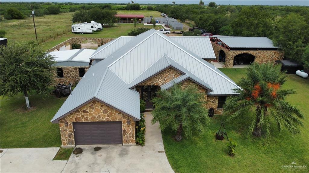 an aerial view of a house with a yard and lake view