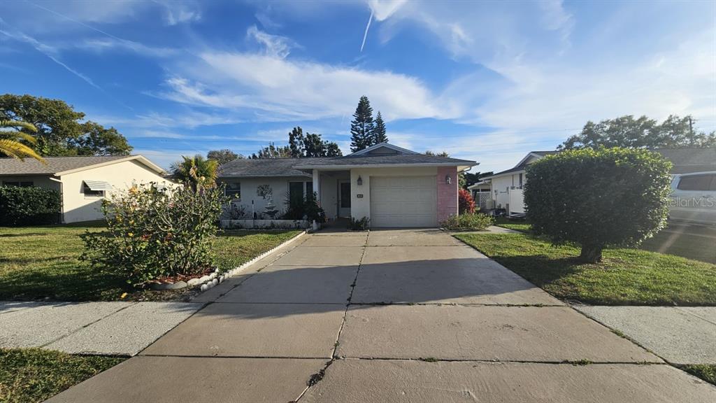 a front view of a house with a yard and a garage