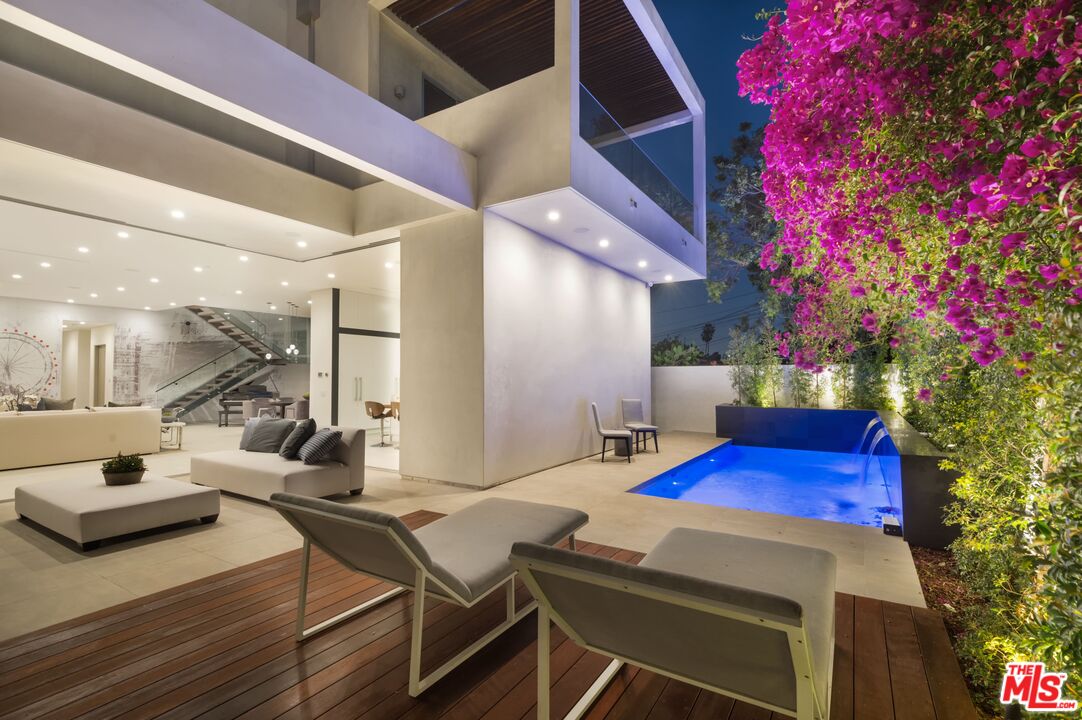 a view of a dining table and chairs in the patio