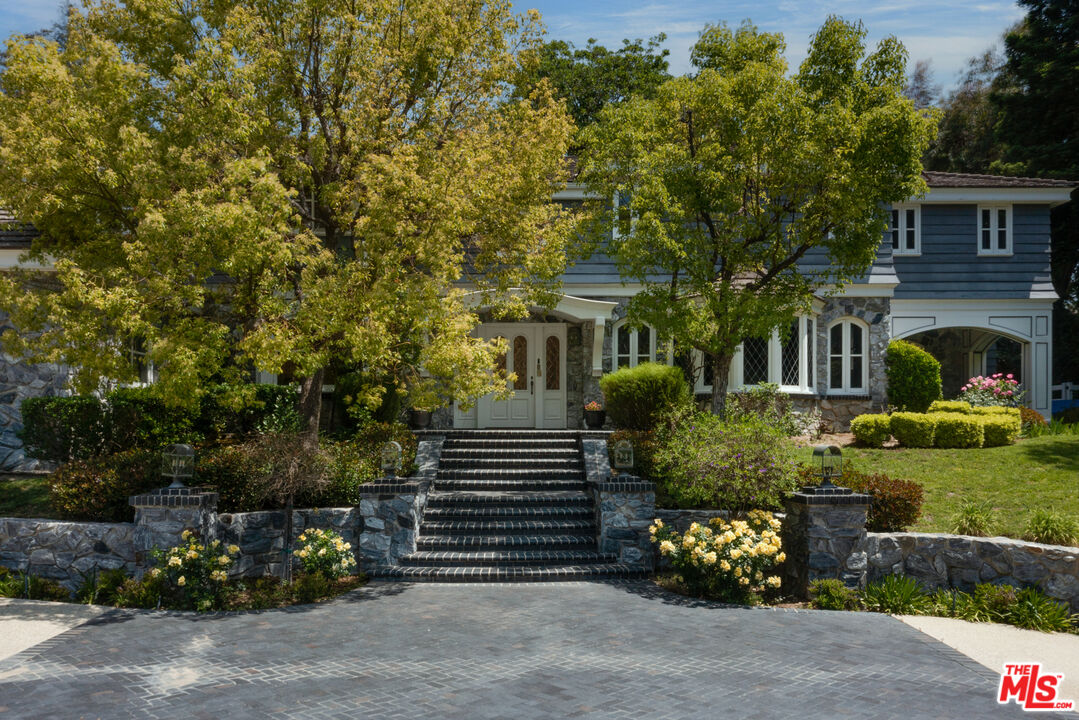 a front view of a house with a garden