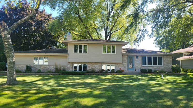 a view of a house with a swimming pool and a yard