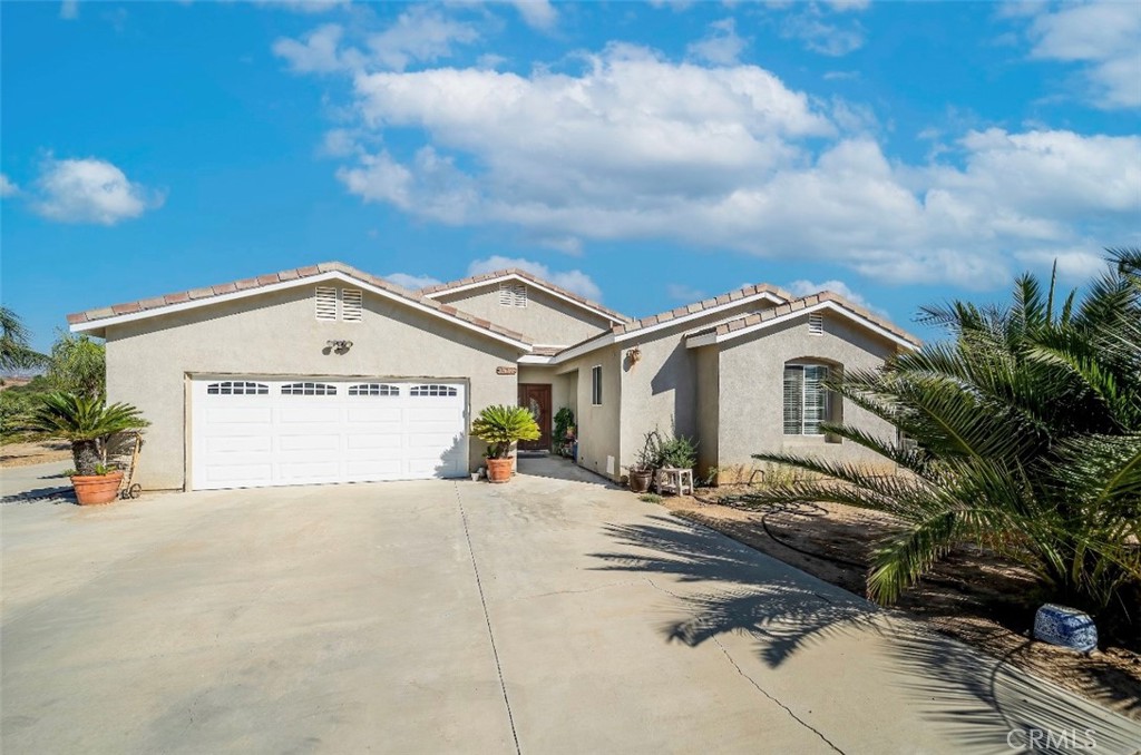 a view of a house with a yard and garage