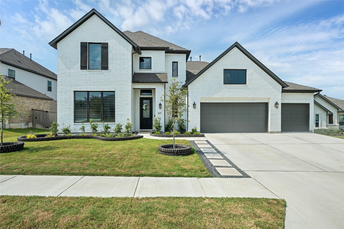 a front view of a house with a yard