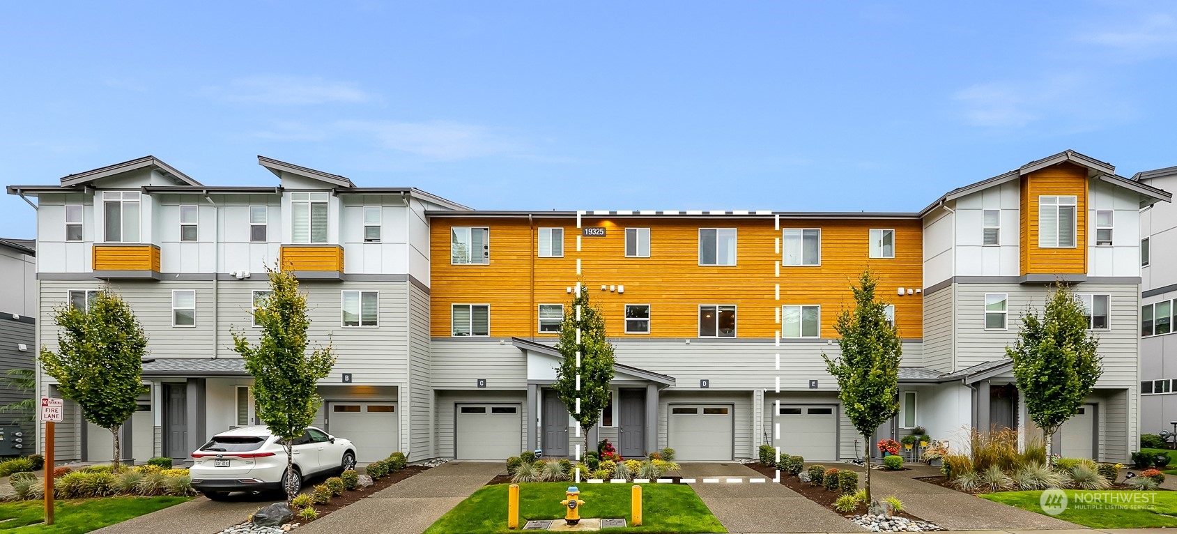 a view of multiple houses with a street