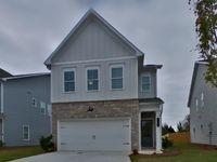 a front view of a house with garage