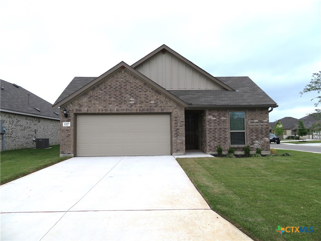 a front view of a house with a garden and yard