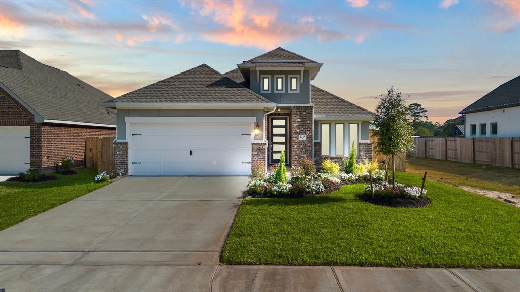 a front view of house with a garden