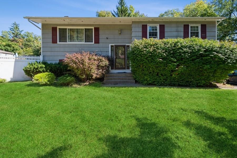 Split foyer home featuring a front lawn