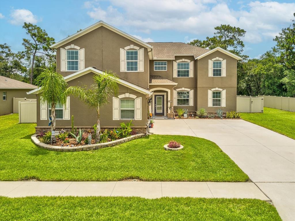 a front view of a house with a yard