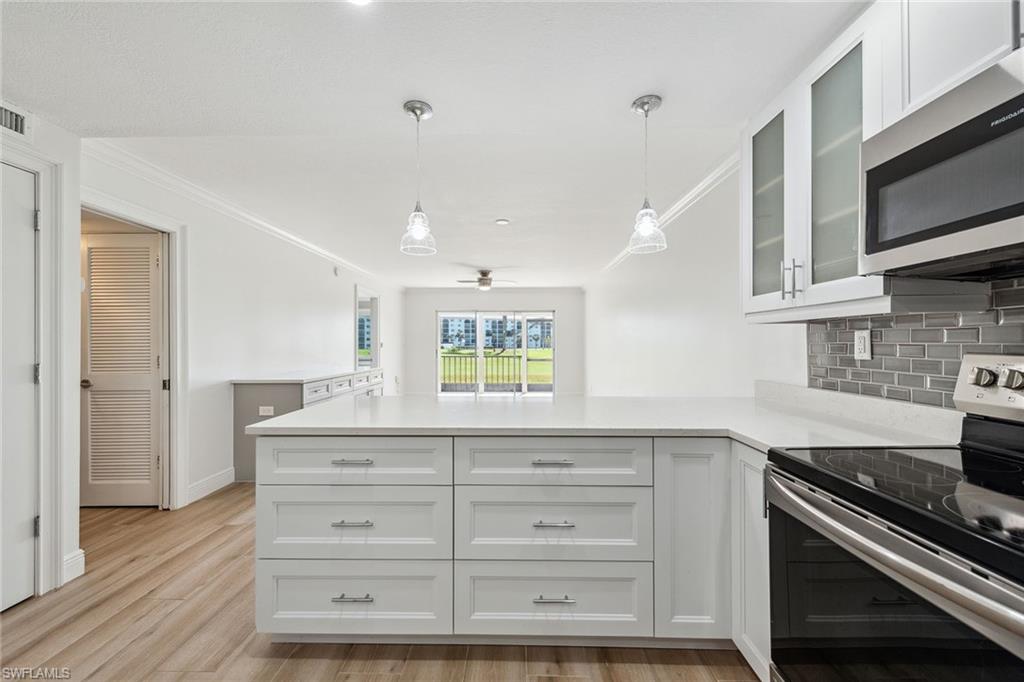 a kitchen with a stove and a microwave