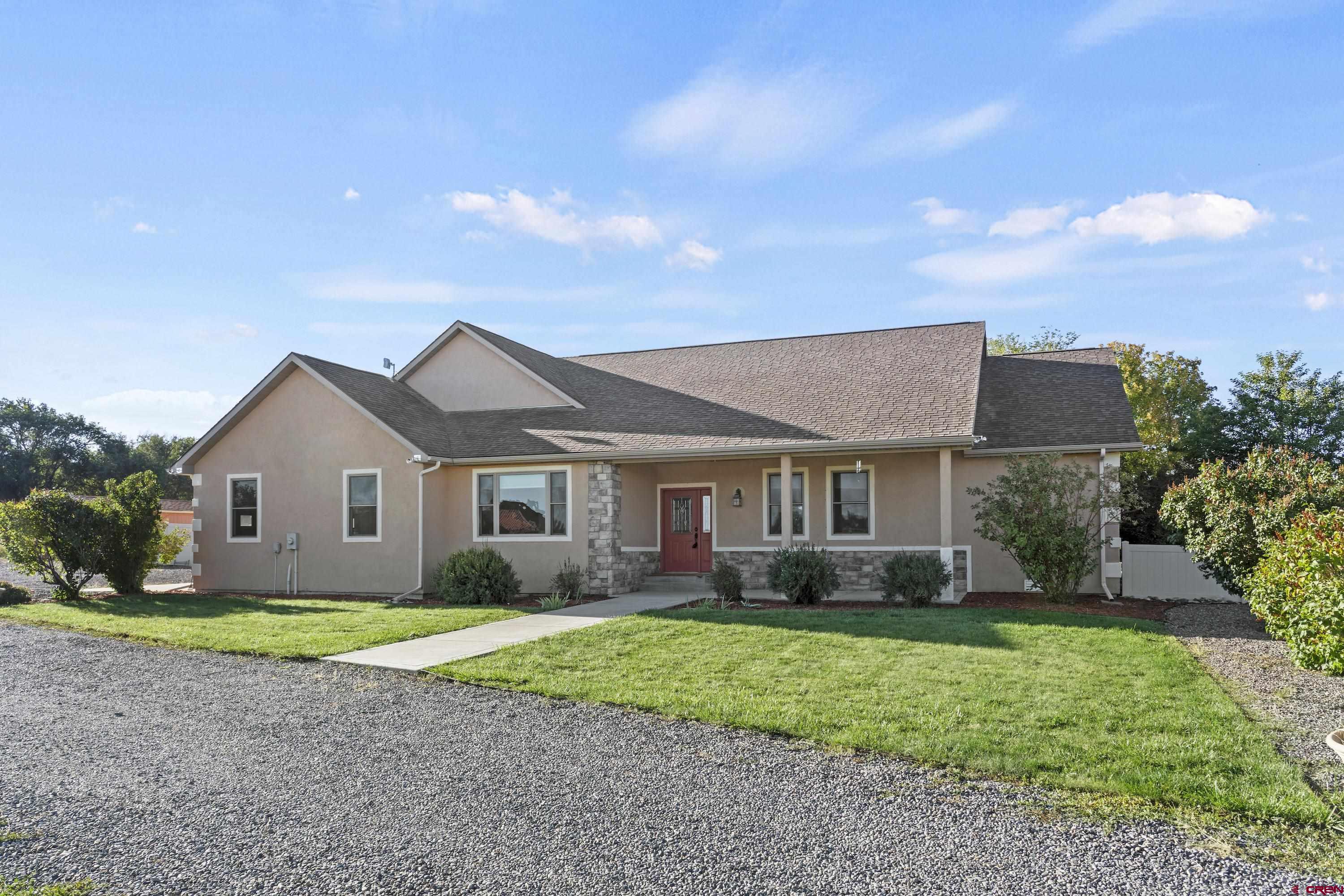 a front view of house with yard and green space