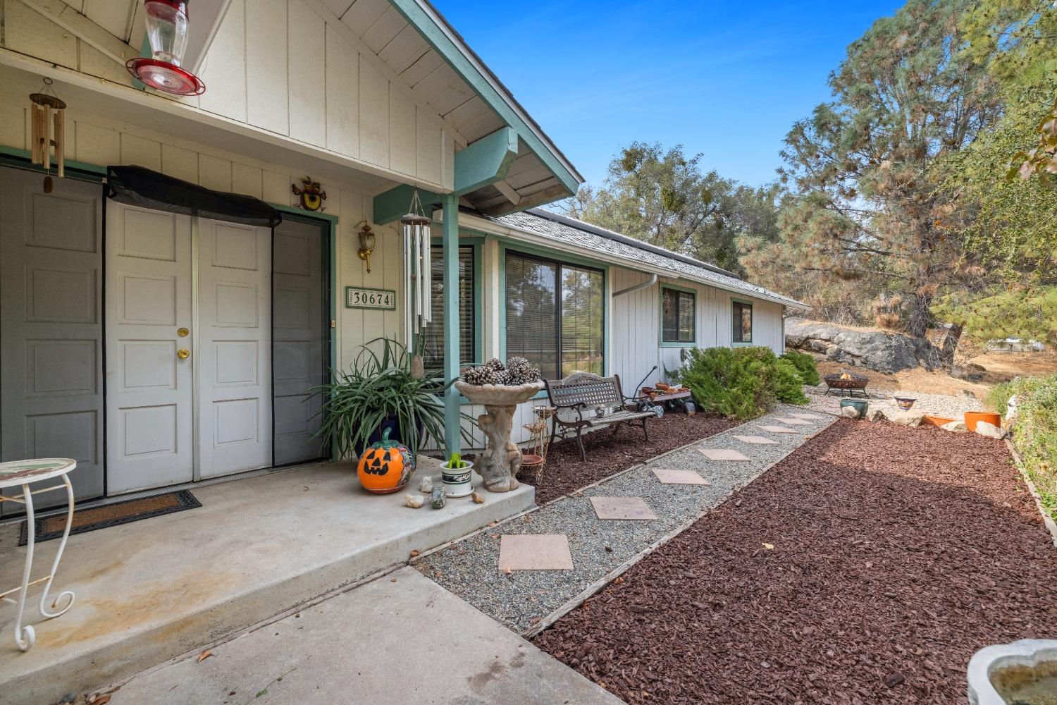 a wooden bench sitting in front of a house