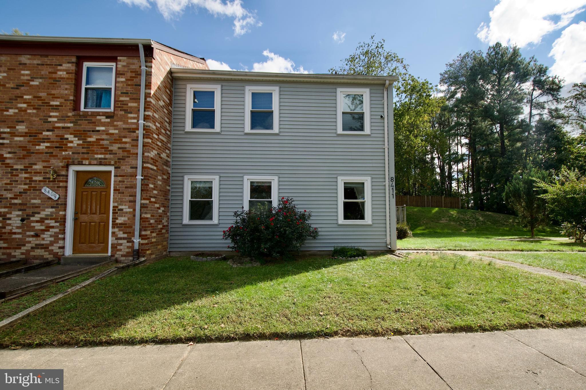 a view of a house with a yard and plants