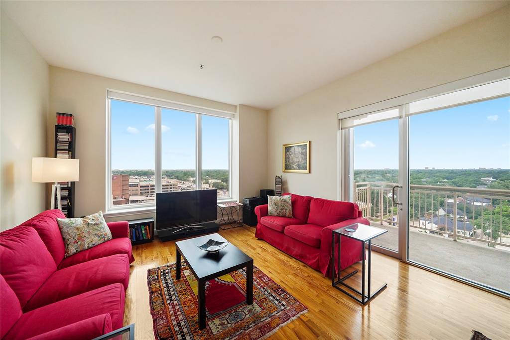 a living room with furniture city view and large windows