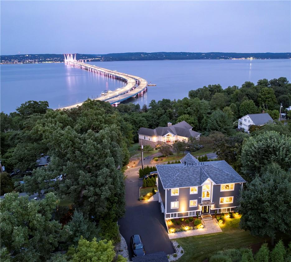 Aerial view at dusk featuring a water view