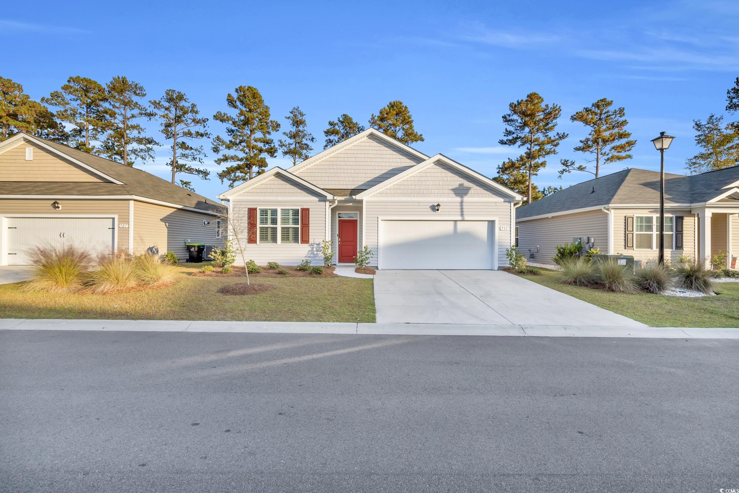 Ranch-style home featuring a garage and a front la