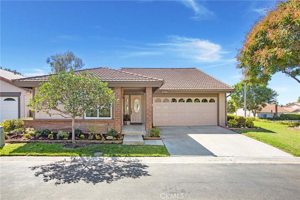 a front view of a house with a garden