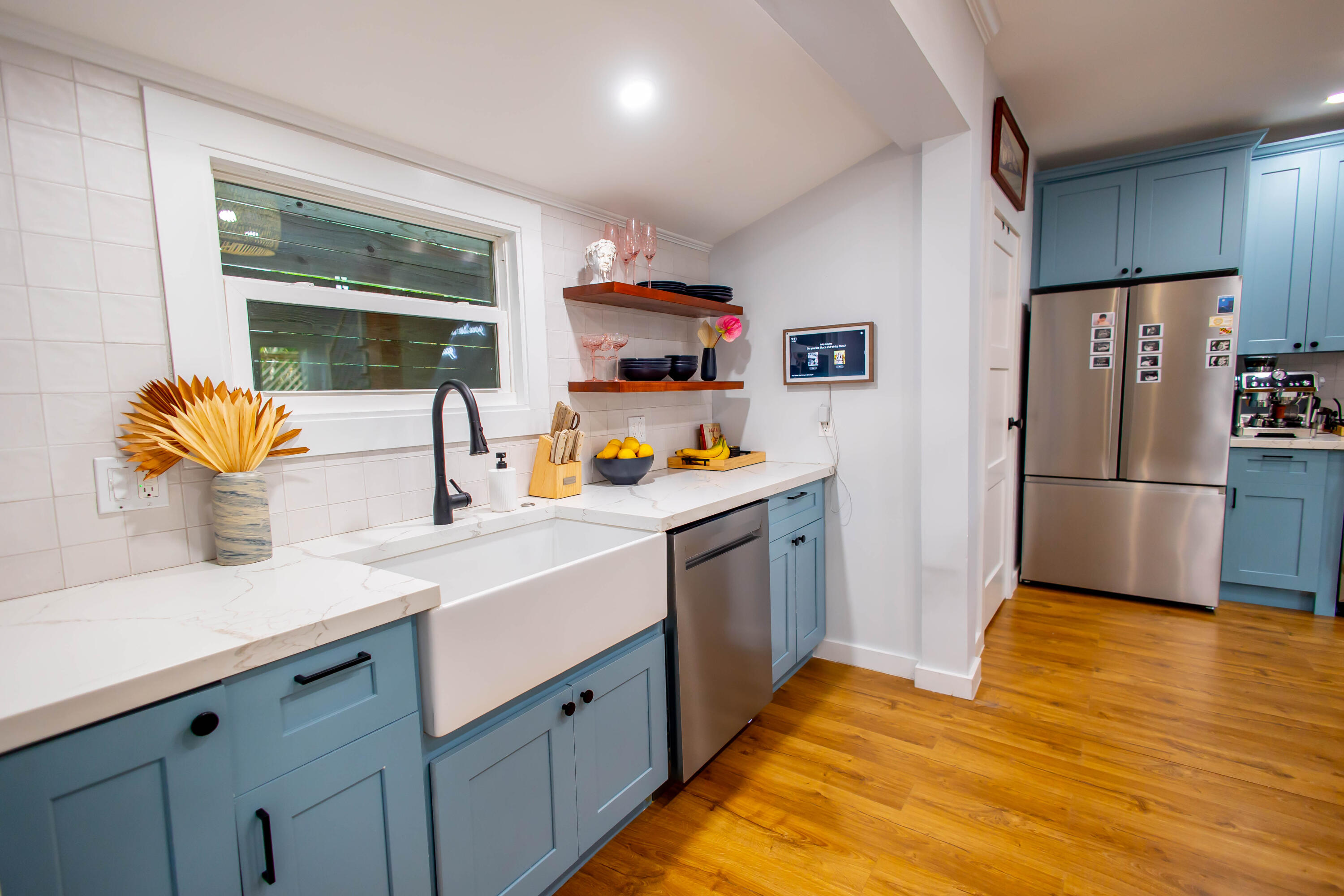 a kitchen with stainless steel appliances granite countertop a refrigerator and a sink