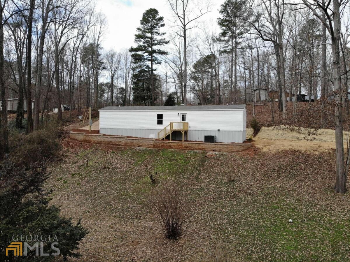 a view of a white house with a yard covered in snow