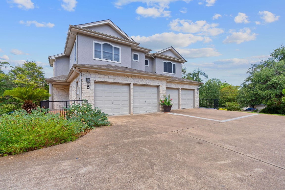 a front view of a house with a yard and a garage