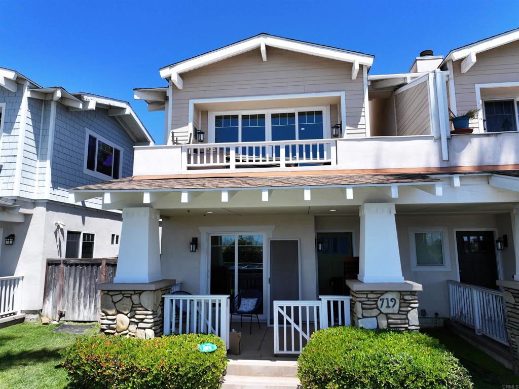 a front view of a house with entryway and a yard