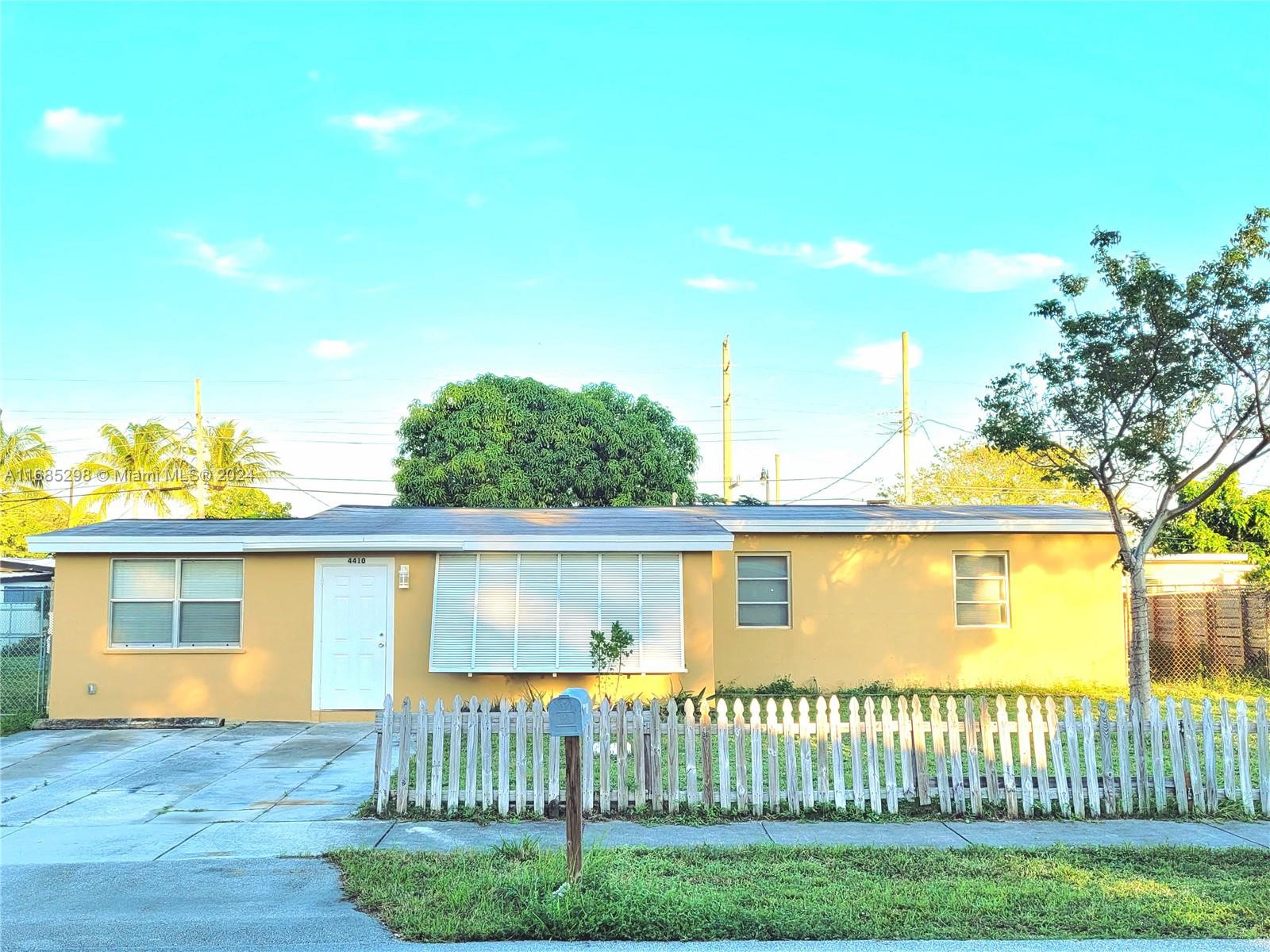 a view of a house with a yard and a garden