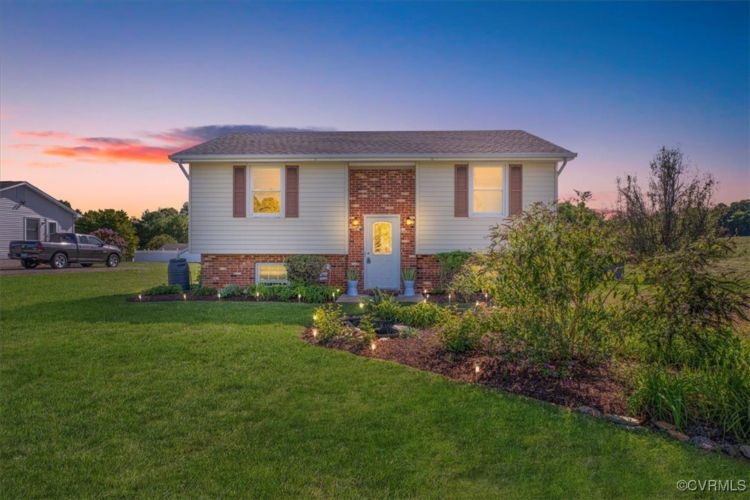 a front view of a house with a garden