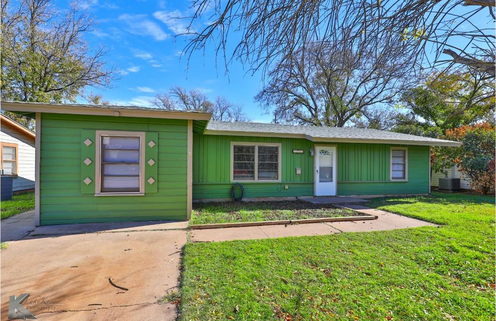 Ranch-style home with a front lawn and central AC