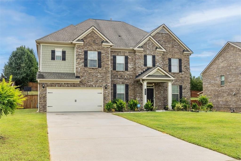 a front view of a house with a yard