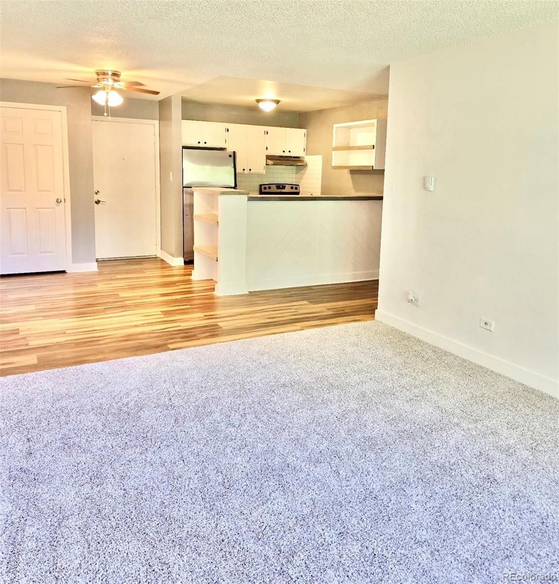 a view of a kitchen with wooden floor