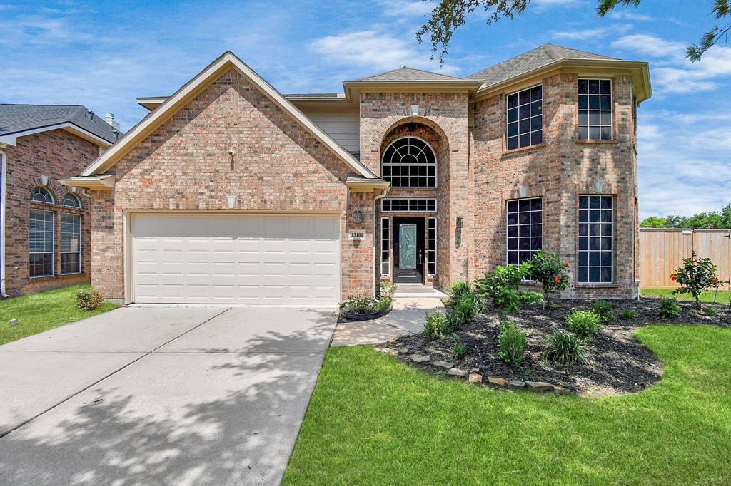 a front view of a house with a yard and garage