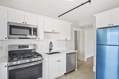 a kitchen with cabinets stainless steel appliances and a counter space