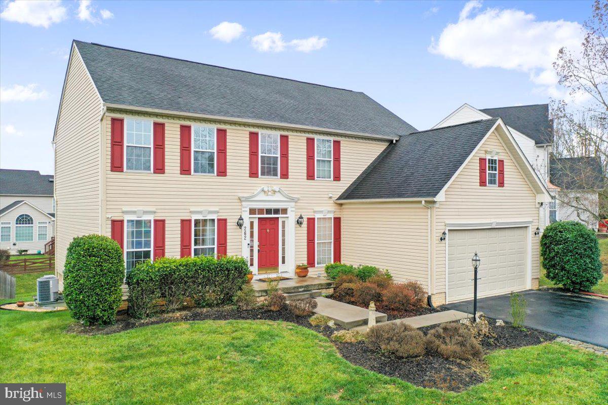 a front view of house with yard and green space