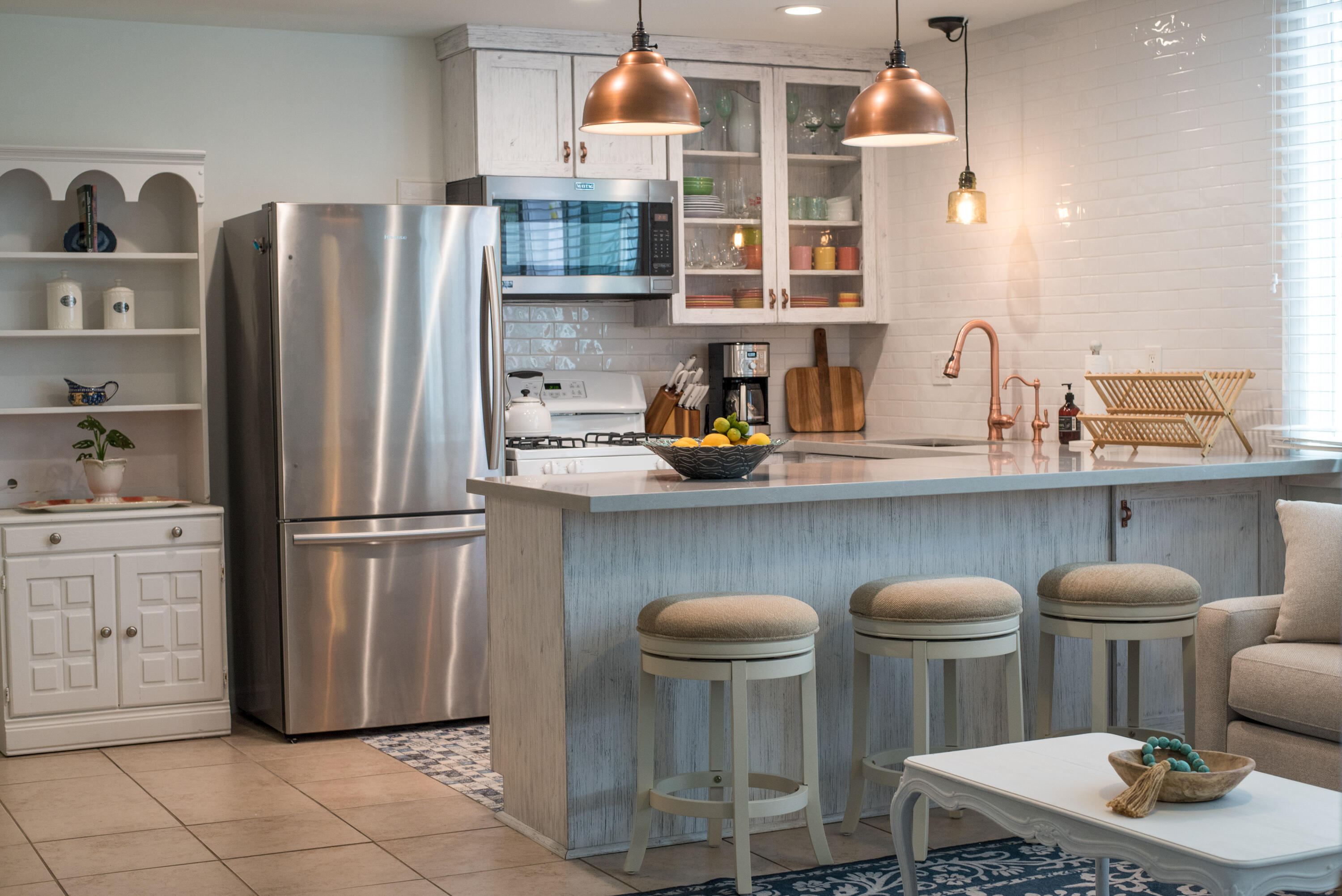 a kitchen with stainless steel appliances a refrigerator a sink a stove and cabinets