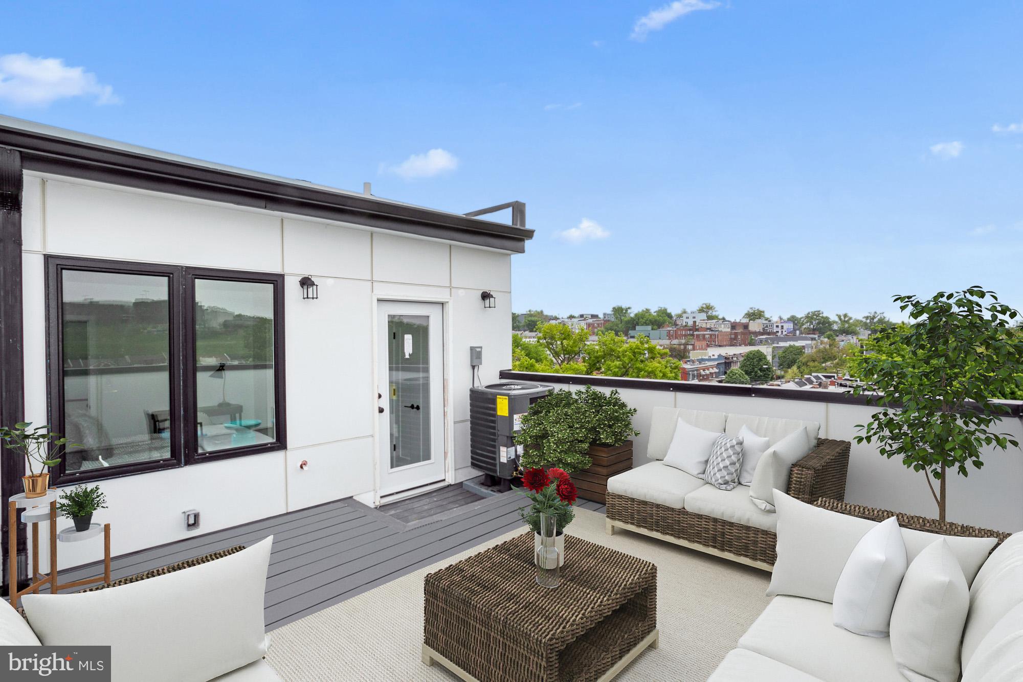 a balcony with furniture and potted plants