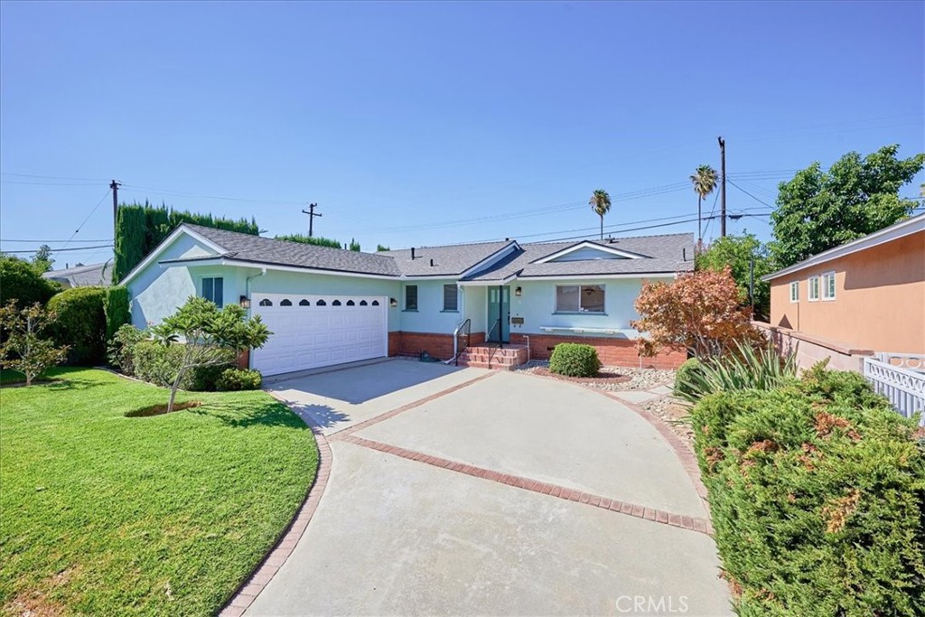 a view of a house with pool and a yard