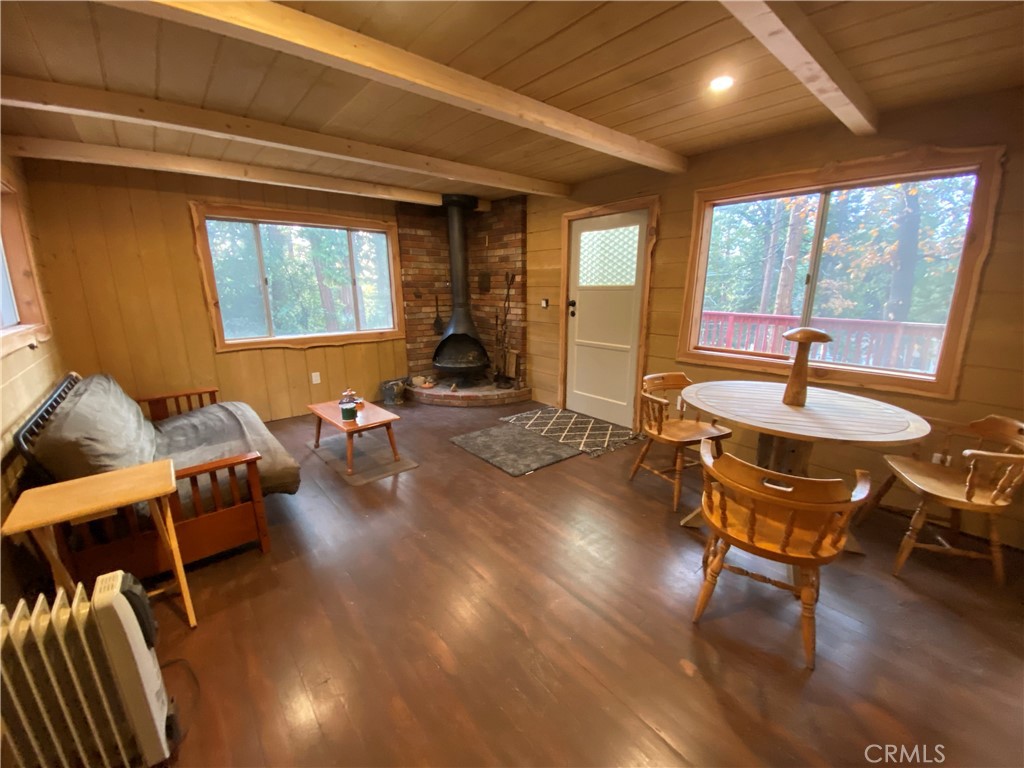 a living room with furniture a table and wooden floor