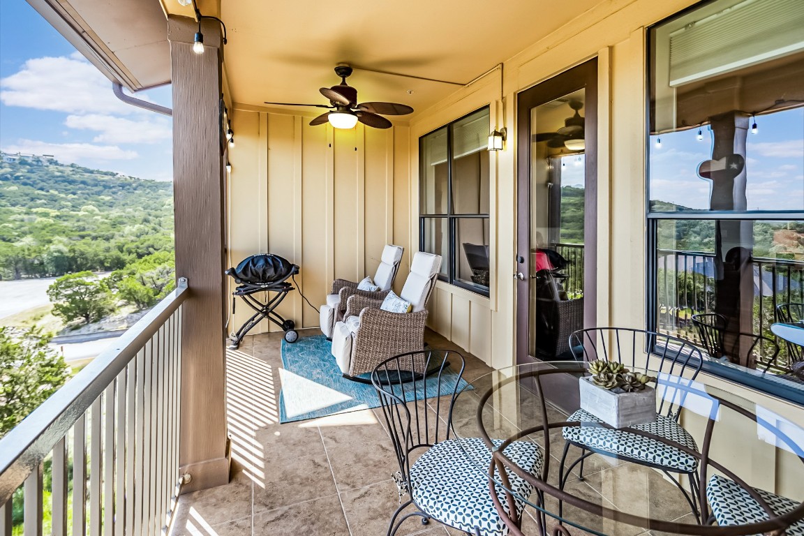 a balcony view with a couch and wooden floor