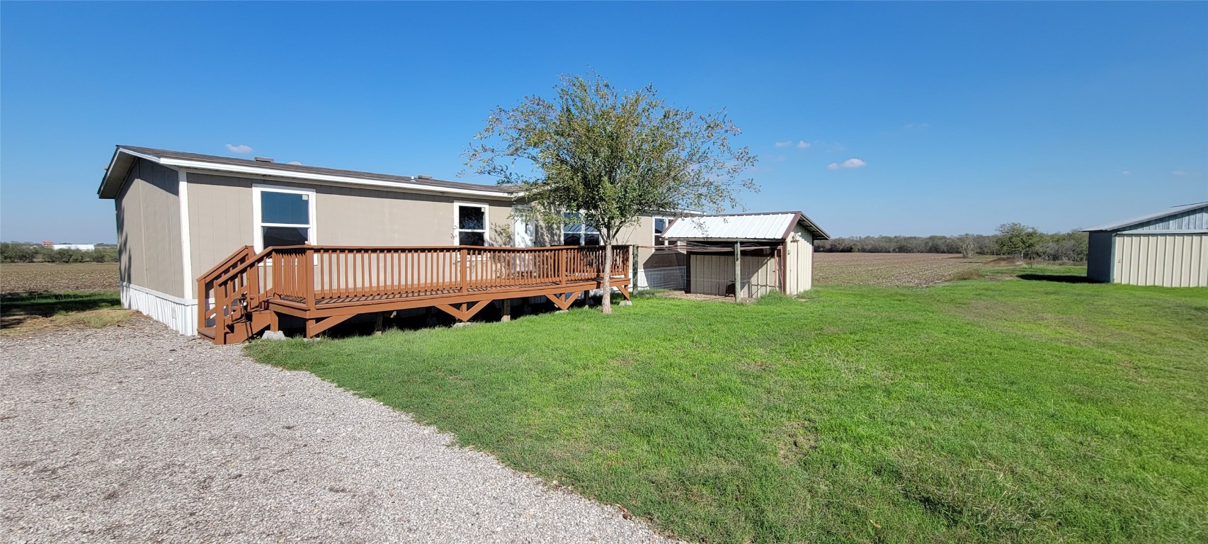 a view of a house with backyard and porch