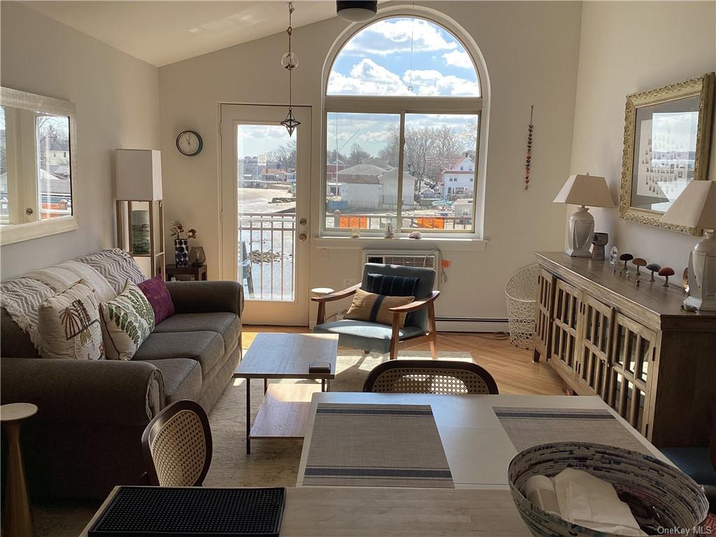 a living room with furniture fireplace and a large window