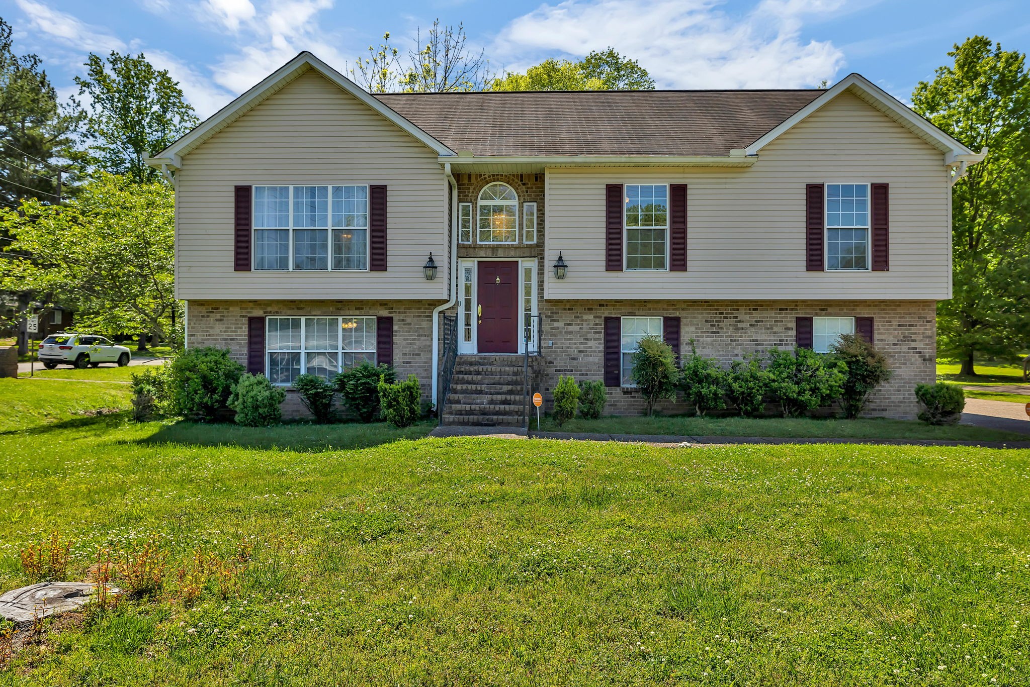 a front view of a house with garden