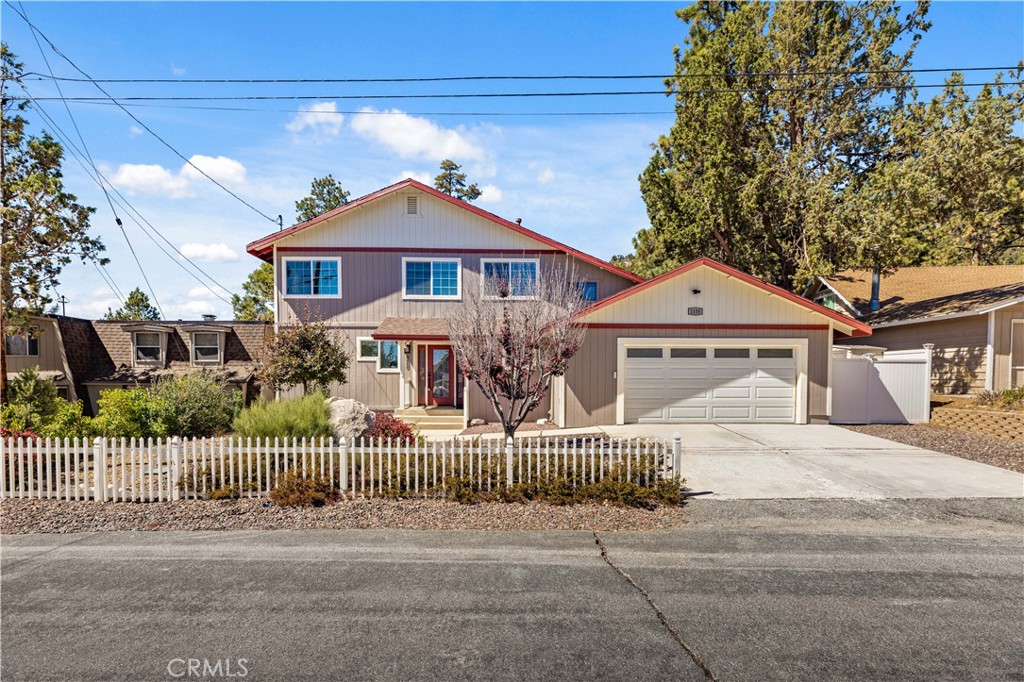 a front view of a house with iron fence