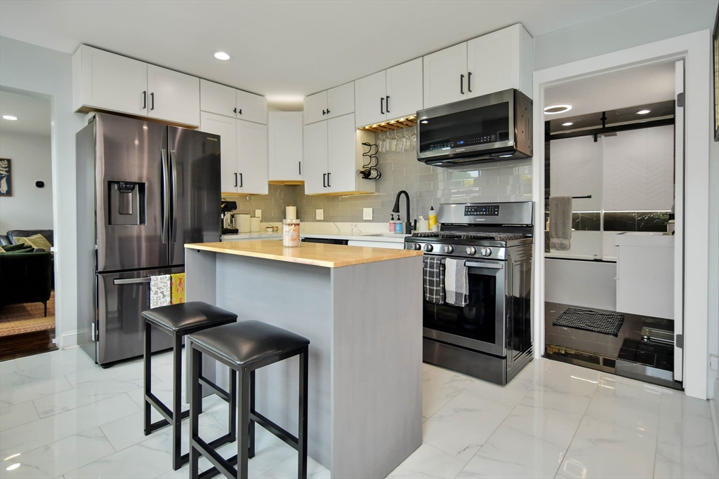 a kitchen with stainless steel appliances a refrigerator stove and sink