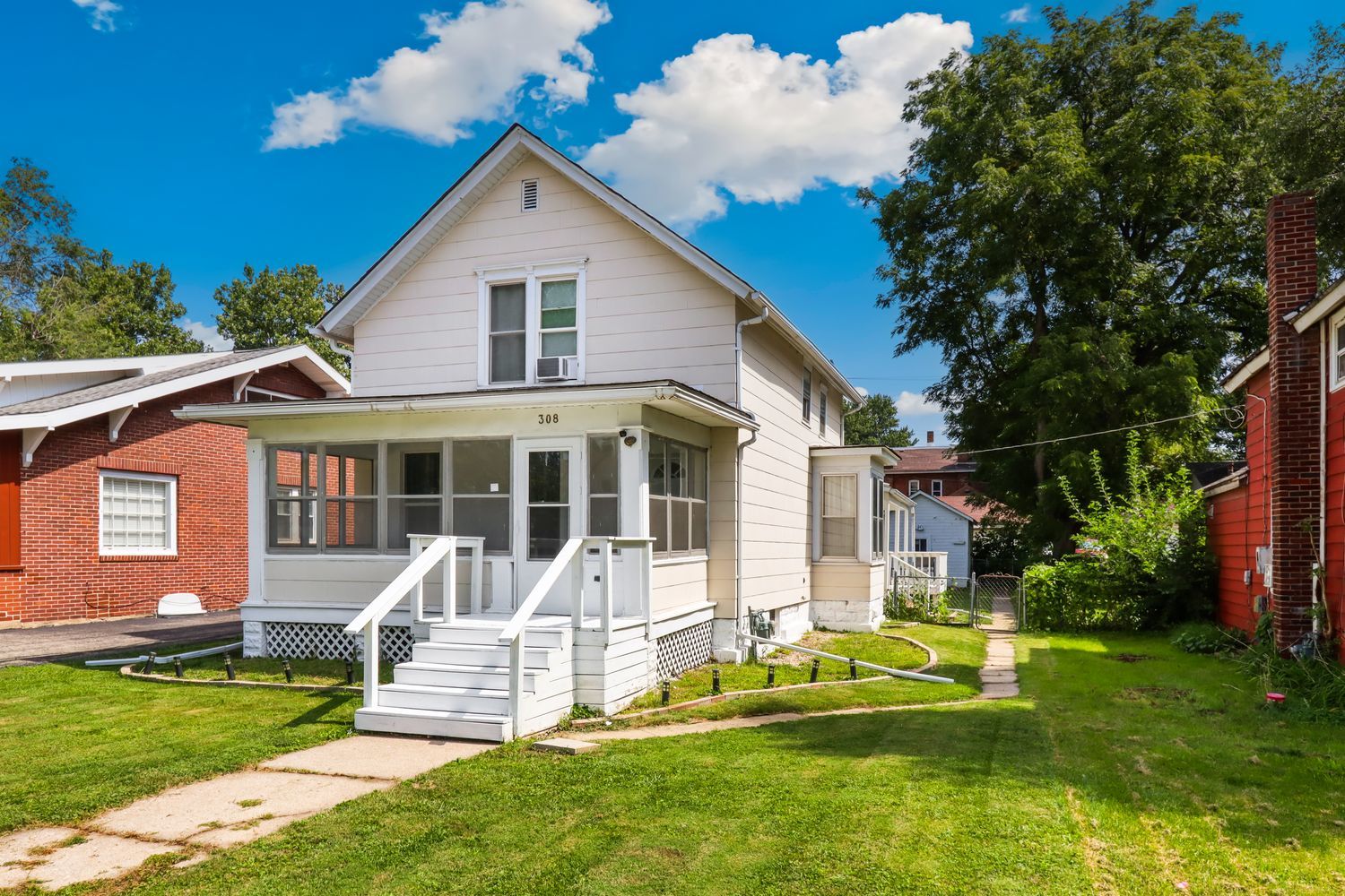 a front view of a house with a yard table and chairs