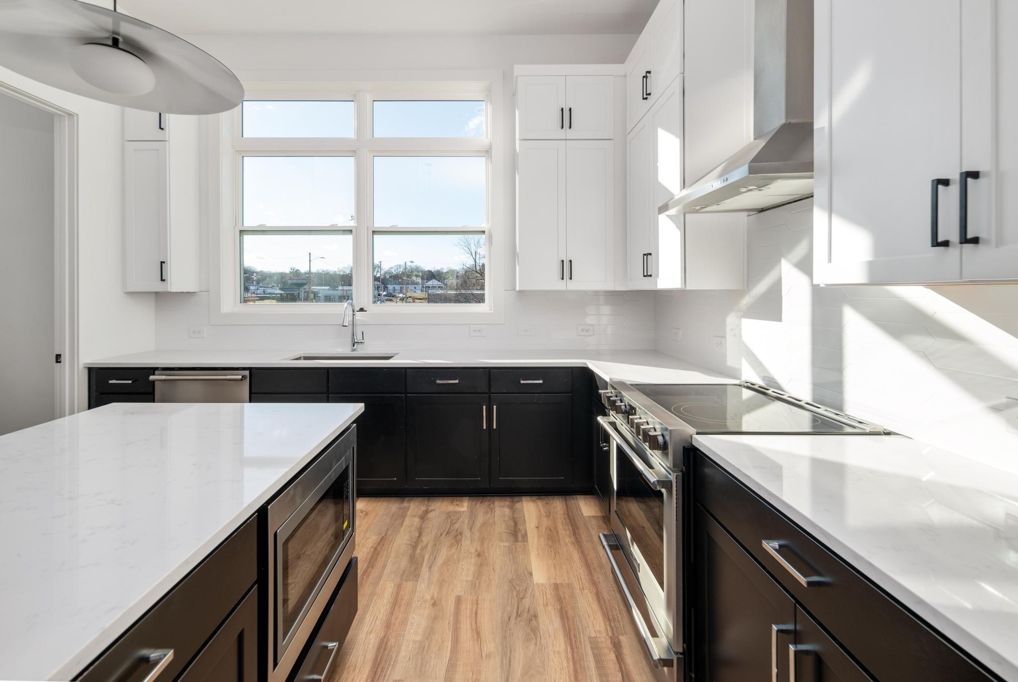 a kitchen with a sink a window and cabinets