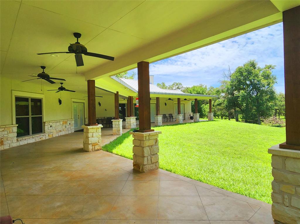 a view of a house with backyard and porch